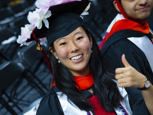 Female giving thumbs up at graduation
