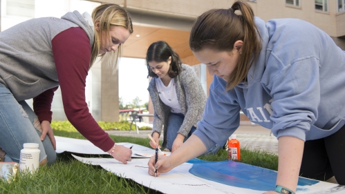 Phi Sigma Rho sorority members design and paint for the upcoming bed races