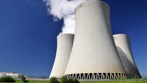 Nuclear energy towers against a blue sky.