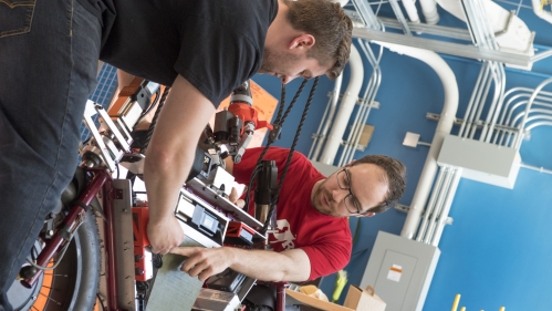 Two male students working in robotics lab