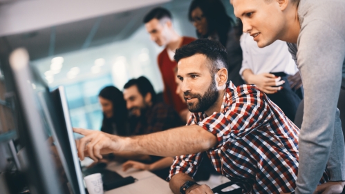 Male students working at a computer.