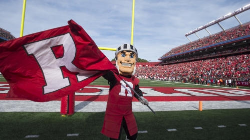 Scarlet Knight mascot holding a block R flag at SHI stadium