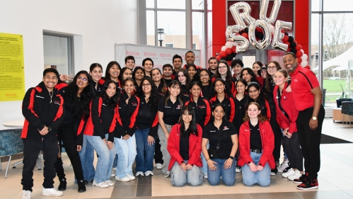 Large group of engineerng ambassadors wearing red and black jackets.