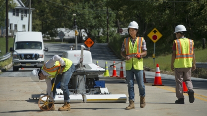 Workers in hard hats working on road with RABiT