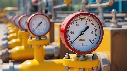 Red pressure meters on yellow natural gas piplines.