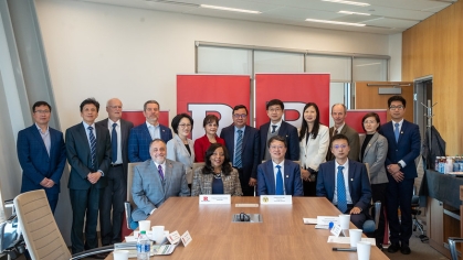 Large group photo in a conference room.