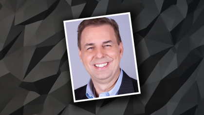 Head shot of smiling male on a black graphic