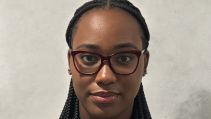 Head shot of a female college student. She is wearing glasses and her hair is braided.