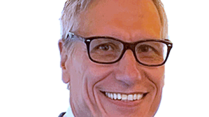 Headshot of male with short grey hair with eyeglasses, wearing a suit and tie..