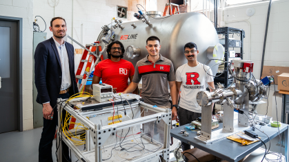A professor and his students in a lab