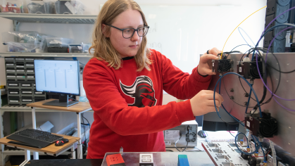 A Rutgers Engineering student uses a 3D printer