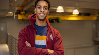 Rutgers sophomore poses for a photo arms crossed within the School of Engineering. 