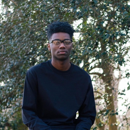 Student Tyriek Bryant seated outdoors