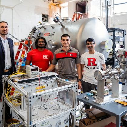 A professor and his students in a lab