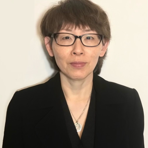 Headshot of female with short dark brown hair with eyeglasses.