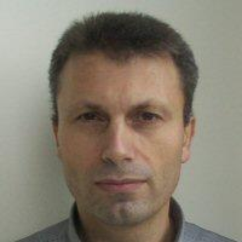 Headshot of male with short hair.