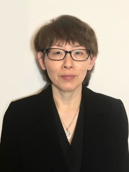 Headshot of female with short dark brown hair with eyeglasses.