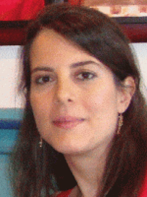 Headshot of woman with long brown hair.