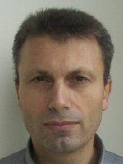 Headshot of male with short hair.