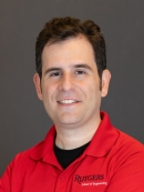Headshot of male with short brown hair, wearing a red Rutgers School of Engineeirng polo shirt.
