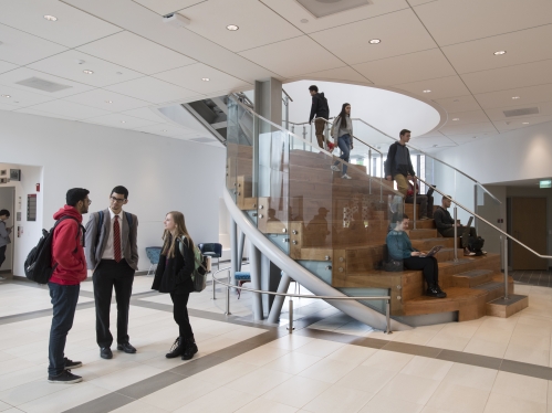 Bhumit Patel (SOE '21), Alec Pizarro (SOE '21), and Elizabeth Niemic (SOE '22) chat in the atrium of the Richard Weeks Hall of Engineering, 2019