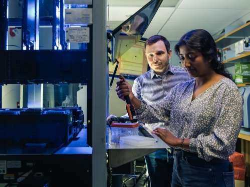 Student and professor in lab.