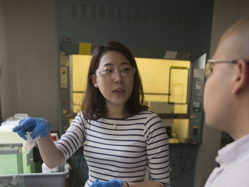 female and male graduate students working in lab