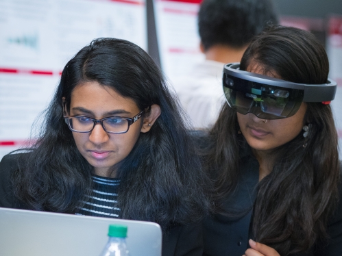 Female student with another female student wearing 3D virtual googles
