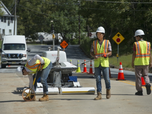 Workers in hard hats working on road with RABiT