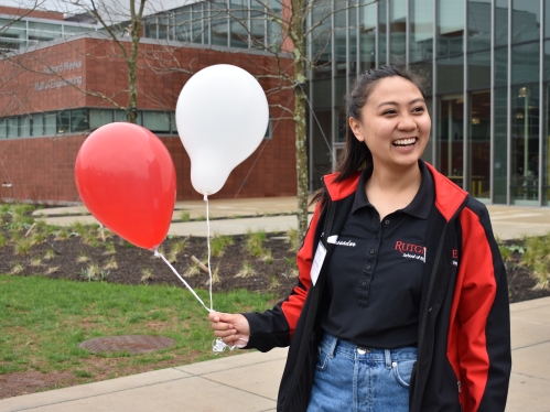 Student ambassador holding balloons