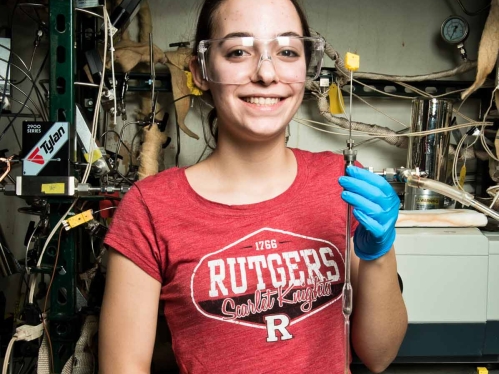 female student wearing goggles in lab