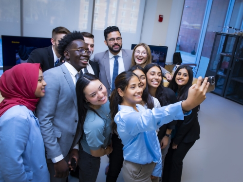Group of students pose for a selfie.