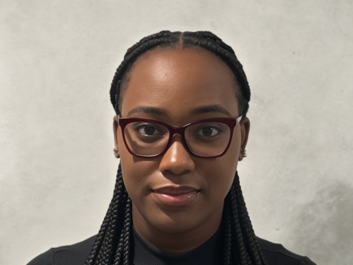 Head shot of a female college student. She is wearing glasses and her hair is braided.