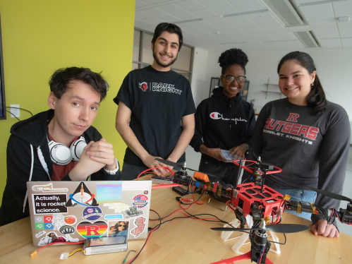 Two male and two female students pose with their aerospace engineering project