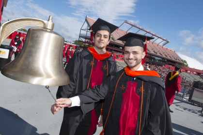 Engineering graduates Subrammanya Shankara Prasad and Obadah Abdulrazeq ring the bell at the 2017 University Commencement
