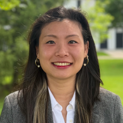 Asian woman with long hair wearing a grey suit jacket and white shirt2