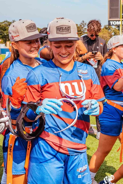  Allison Gandlin (front and center) and her younger sister Valerie (left) and other Staten Island Giants celebrate winning the NFL Flag championship in July at the Tom Benson Hall of Fame Stadium in Canton, Ohio.