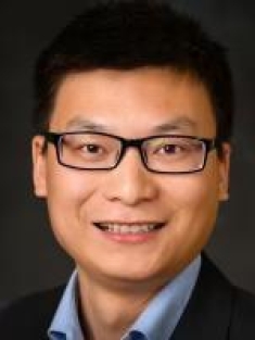 Headshot of Chinese male with short, black hair, wearing eyeglasses.