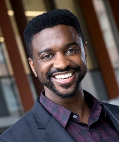 Headshot of Black male with short hair and facial hair.