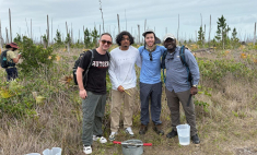 Four males standing in a field in the Bahamas 