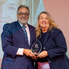 Man presenting award to woman